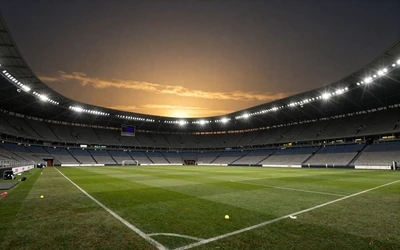 Fu&szlig;ballstadion bei Nacht mit Flutlicht f&uuml;r Sportwetten bei Cleobetra Casino
